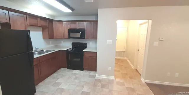a kitchen with stainless steel appliances granite countertop a sink stove and microwave