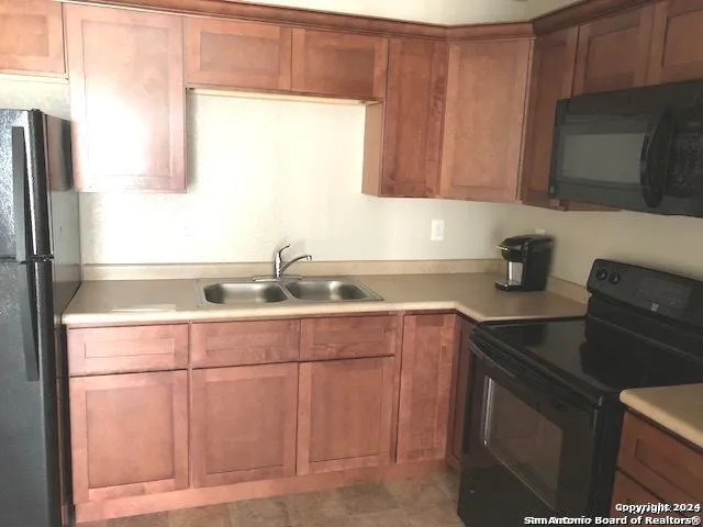 en empty room with windows and chandelier