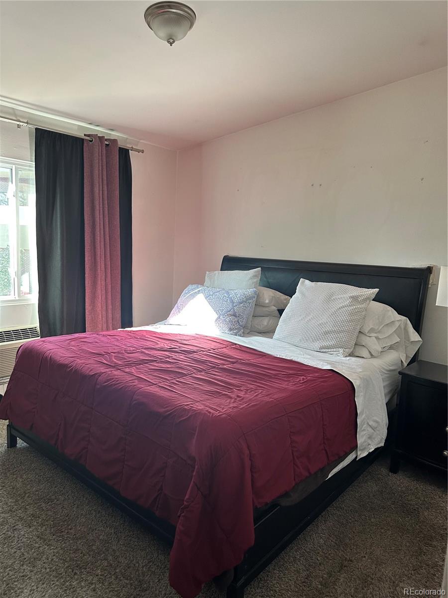 615 South Clinton Street, Unit 9B Denver, CO 80247 - Photo 11 of 24 a bedroom with a bed and window