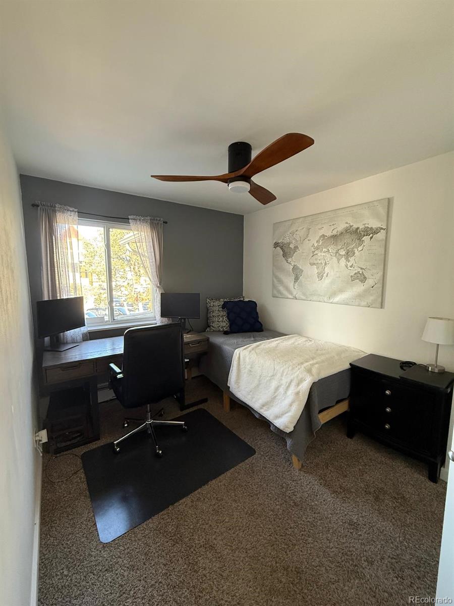 615 South Clinton Street, Unit 9B Denver, CO 80247 - Photo 12 of 24 a bedroom with a bed and a desk