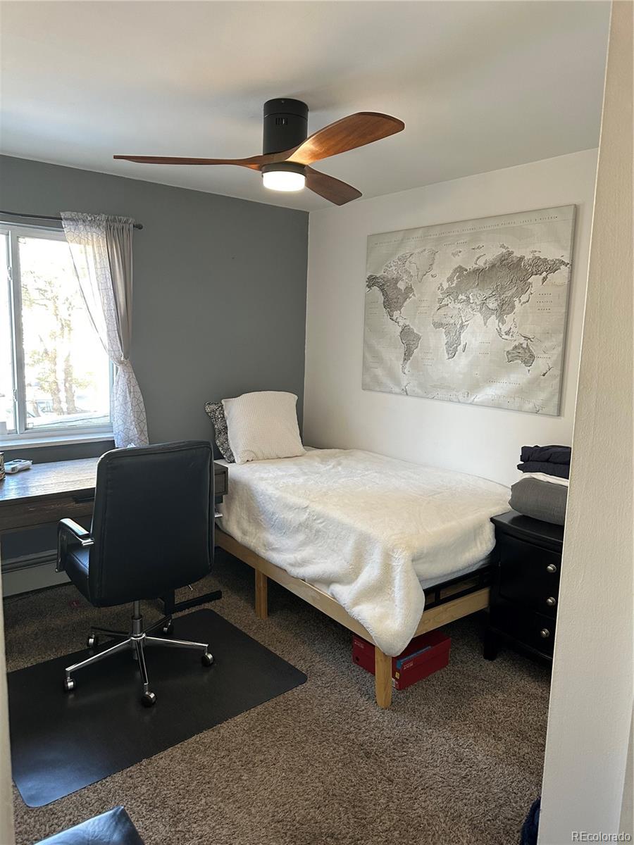 615 South Clinton Street, Unit 9B Denver, CO 80247 - Photo 13 of 24 a bedroom with a bed and a window