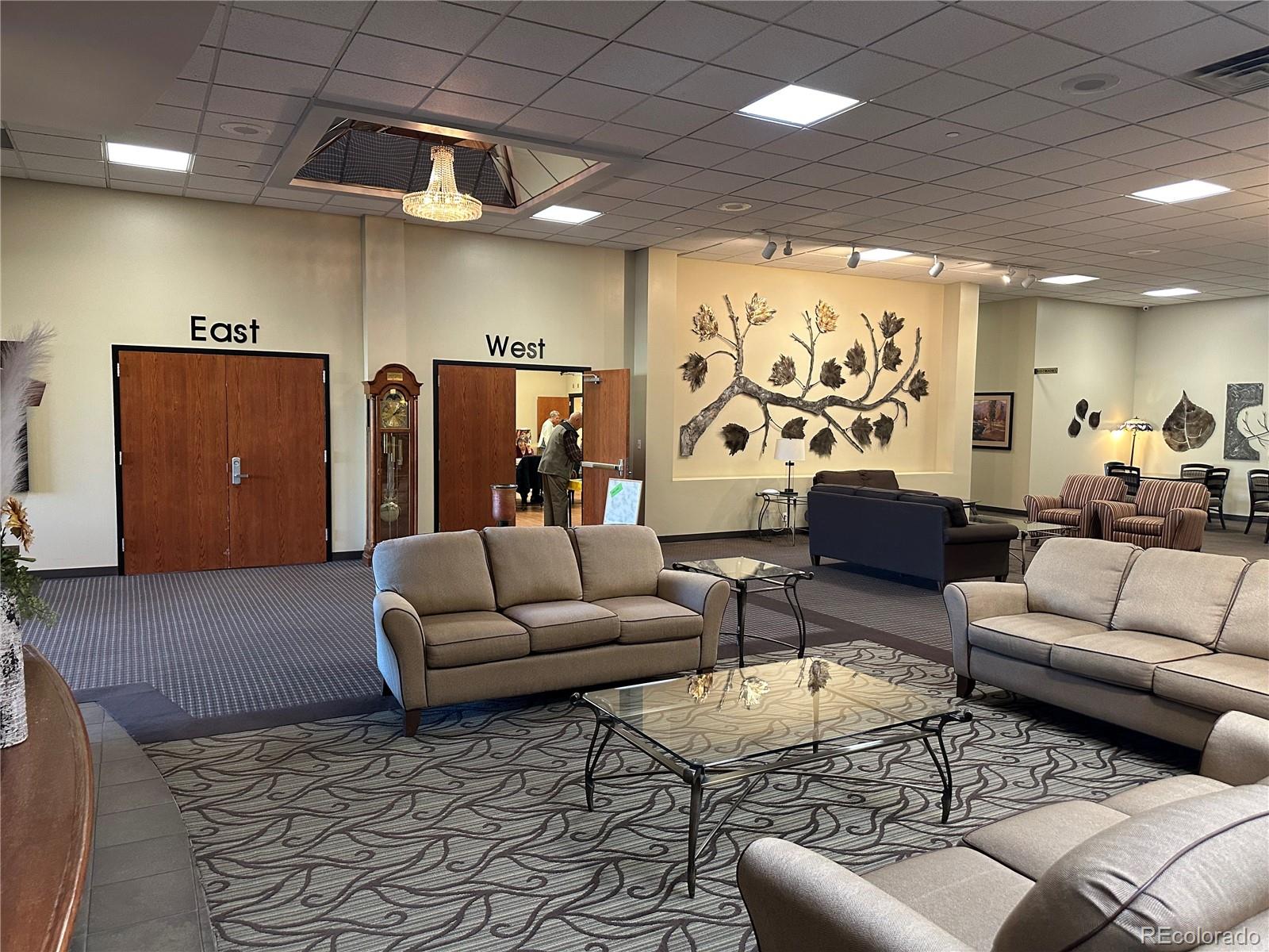 615 South Clinton Street, Unit 9B Denver, CO 80247 - Photo 18 of 24 a living room with furniture and a large window