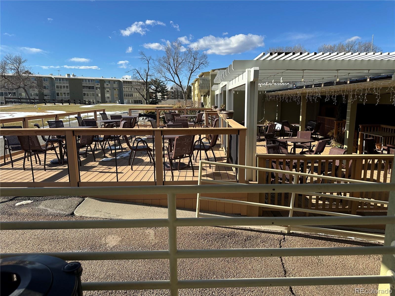 615 South Clinton Street, Unit 9B Denver, CO 80247 - Photo 22 of 24 a view of a chairs and table in a patio