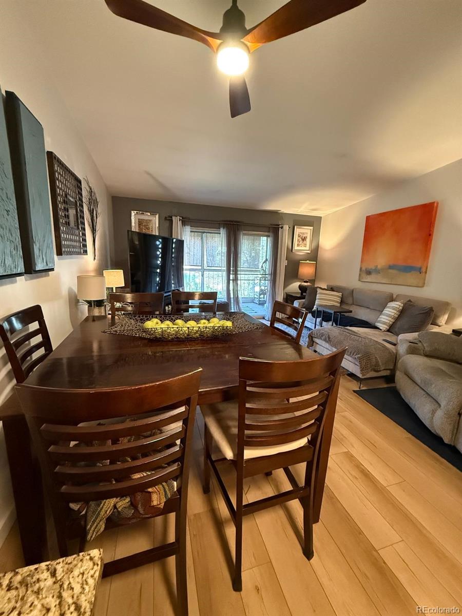 615 South Clinton Street, Unit 9B Denver, CO 80247 - Photo 5 of 24 a living room with a couch a dining table and chairs