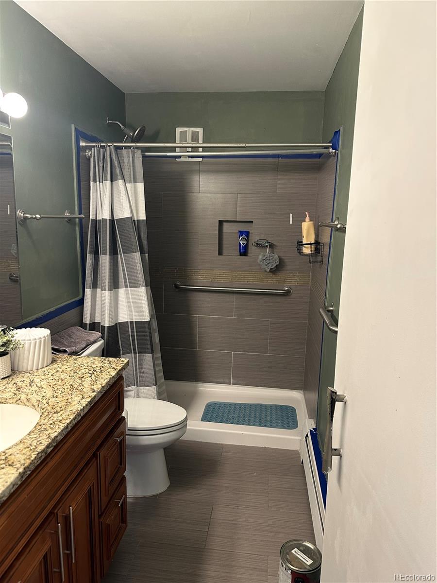 615 South Clinton Street, Unit 9B Denver, CO 80247 - Photo 8 of 24 a bathroom with a granite countertop sink toilet and shower