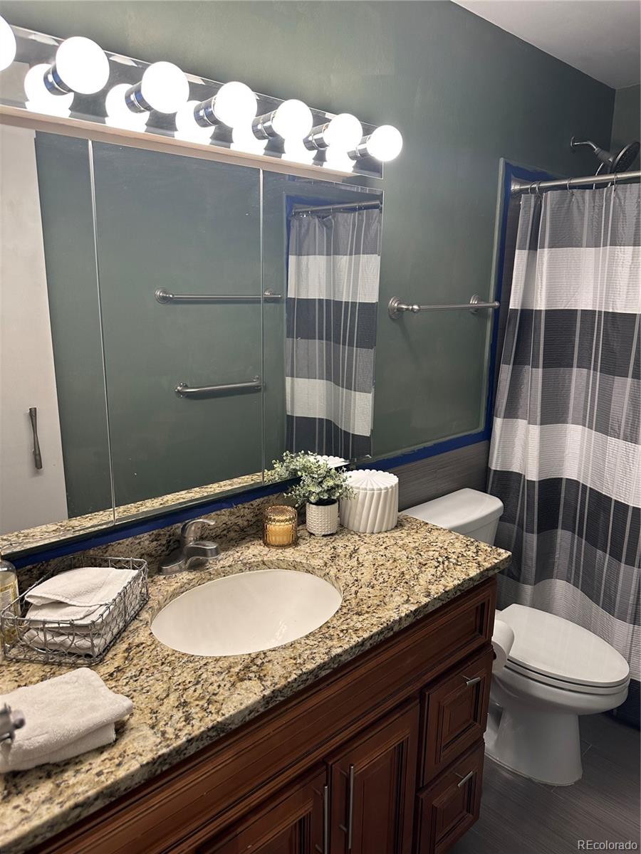 615 South Clinton Street, Unit 9B Denver, CO 80247 - Photo 9 of 24 a bathroom with a sink and mirror
