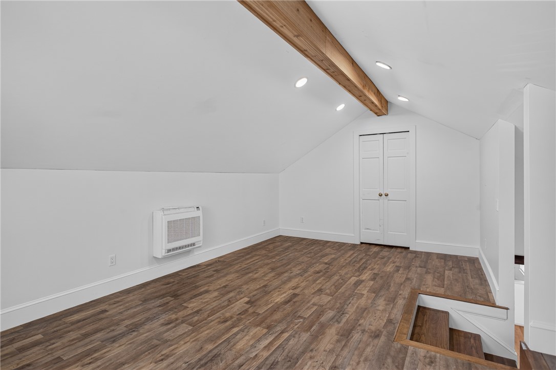 612 Providence Point Drive Seneca, SC 29678 - Photo 21 of 43 Discover a versatile attic space with exposed beam accents, bright recessed lighting, and durable wood flooring.