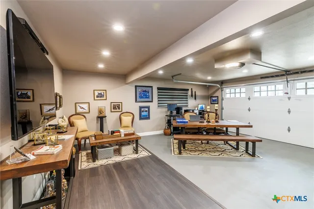 a bedroom with a bed and a flat tv screen on the dresser