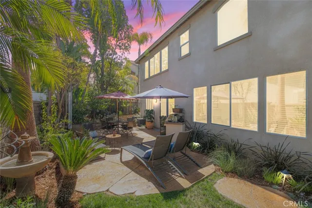 a view of a patio with couches table and chairs and potted plants