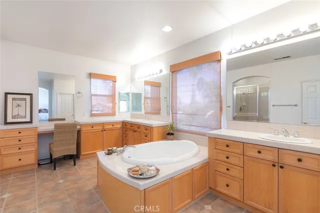 a bathroom with a sink mirror and a shower