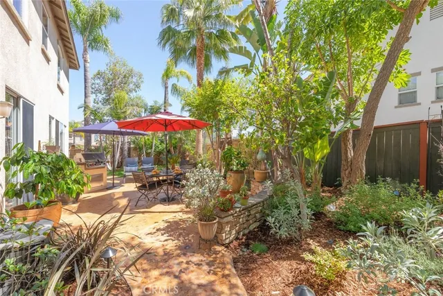 a view of backyard with outdoor seating and trees