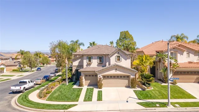 an aerial view of residential house with outdoor space and trees all around