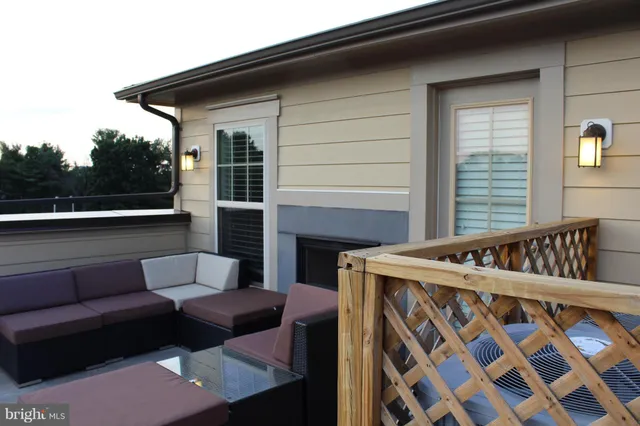 a view of a patio with couches chairs and a fireplace