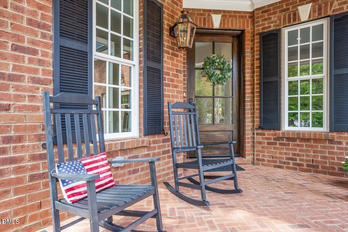 Herringbone design brick front porch. Exterior gas,  Oversized solid mahogany front door with beveled glass and Schlage smart lock.