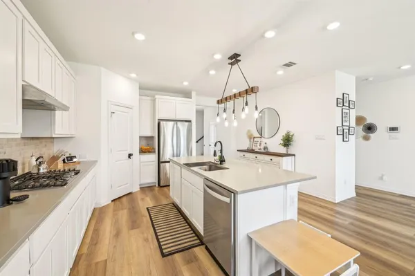 a kitchen with a sink stainless steel appliances cabinets and a counter space