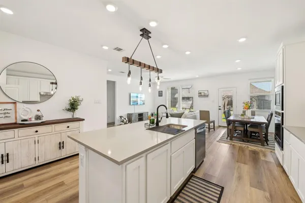 a kitchen with sink stove and cabinets