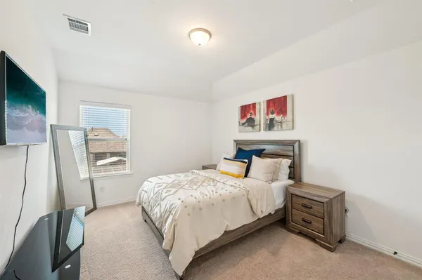 a bedroom with a bed and a flat screen tv