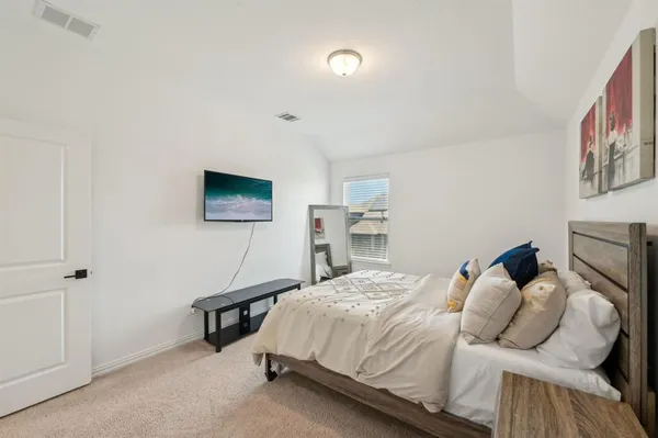 a bedroom with a bed and a flat screen tv