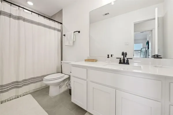 a bathroom with a toilet a sink and a mirror