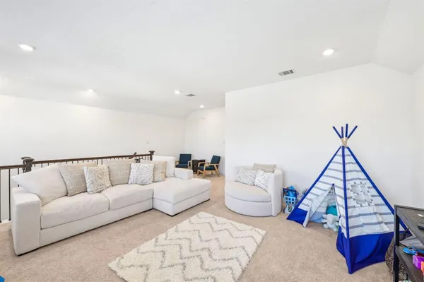 a living room with furniture and white walls