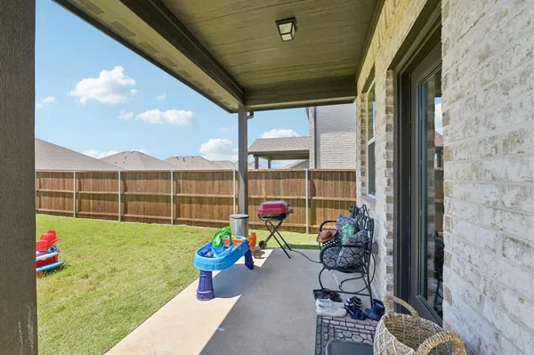 a view of a porch with furniture and garden