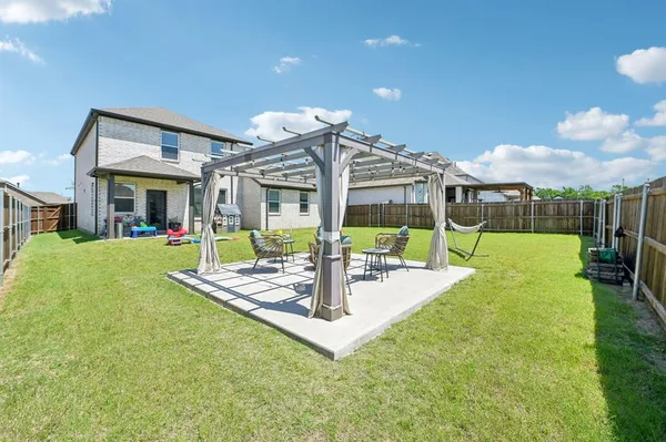 a view of a house with swimming pool and a big yard