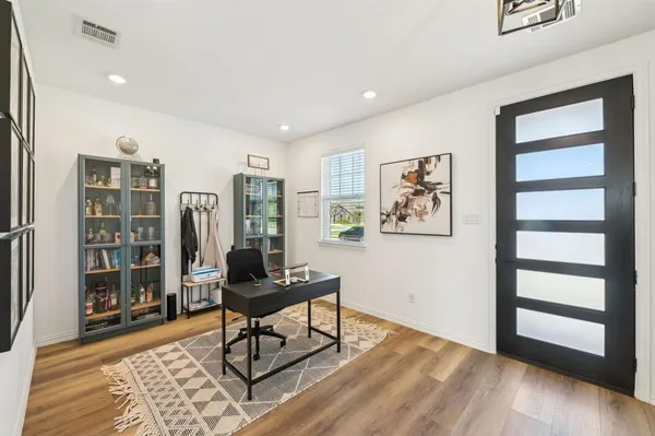 a living room with furniture and wooden floor