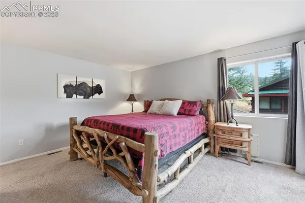 a spacious bedroom with a bed and a window