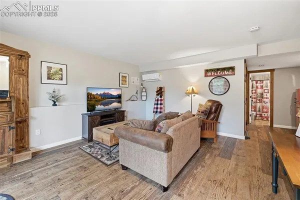 a living room with furniture and a wooden floor