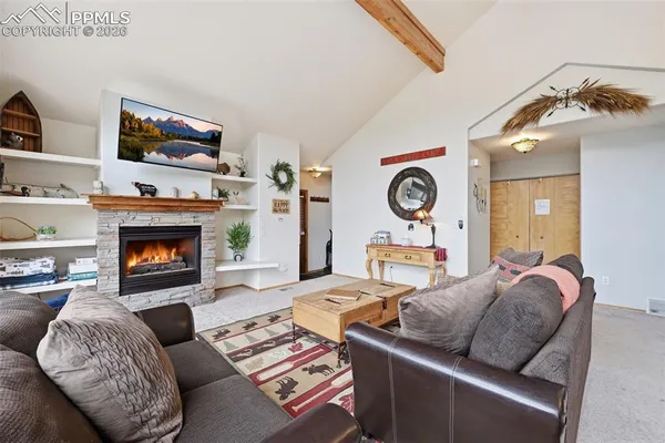 a living room with furniture a clock and a fireplace