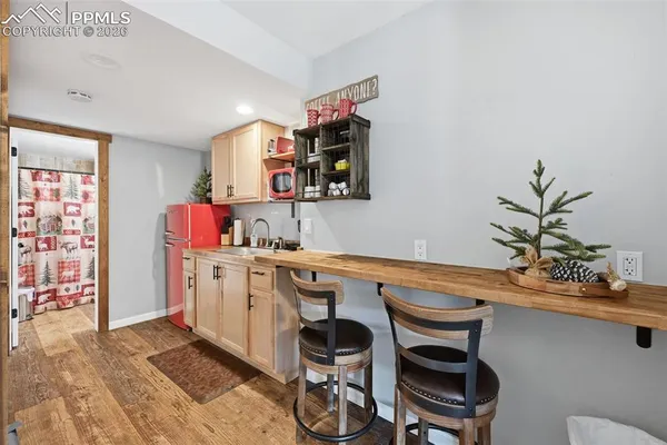 a dining room with stainless steel appliances kitchen island granite countertop a sink and cabinets