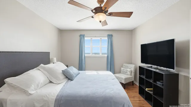 a bedroom with a bed and a flat screen tv