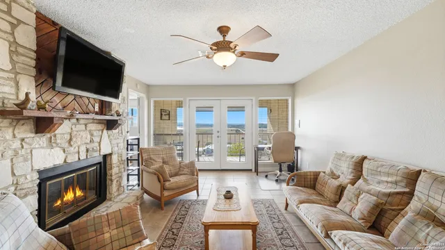 a living room with fireplace furniture and a flat screen tv