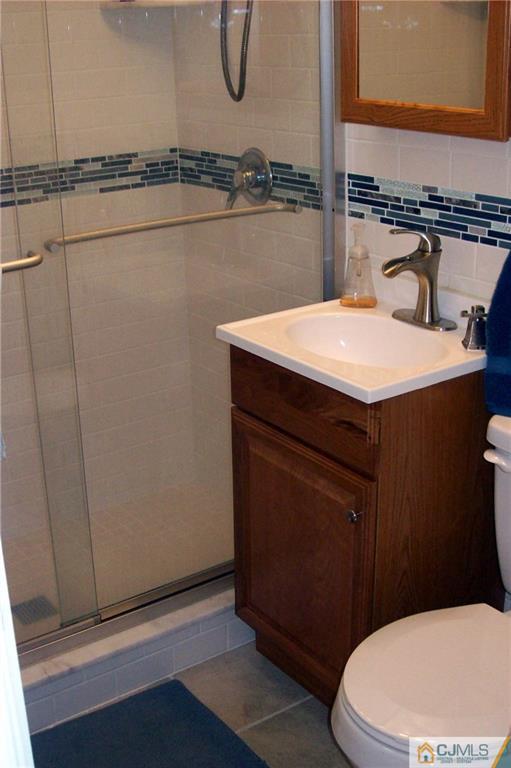 23 Rodney Road East Brunswick, NJ 08816 - Photo 13 of 25 a bathroom with a sink a toilet and shower