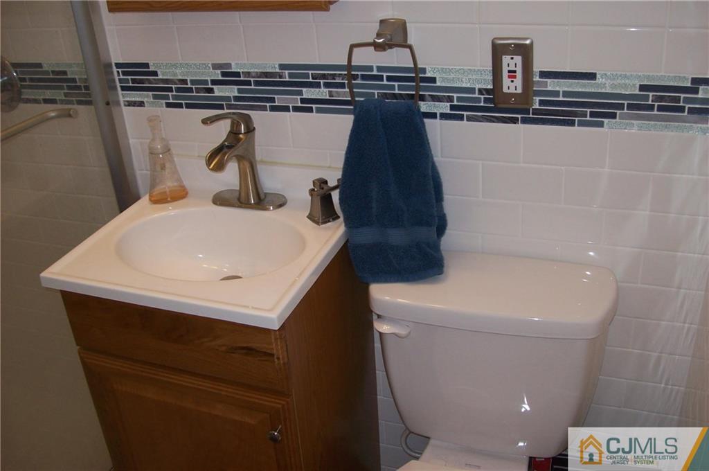 23 Rodney Road East Brunswick, NJ 08816 - Photo 14 of 25 a bathroom with a sink and a toilet