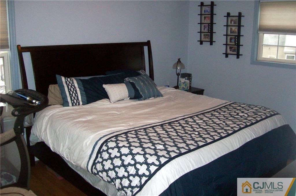 23 Rodney Road East Brunswick, NJ 08816 - Photo 17 of 25 a bedroom with a bed and window