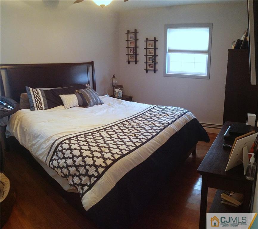 23 Rodney Road East Brunswick, NJ 08816 - Photo 18 of 25 a bed sitting in a bedroom next to a window