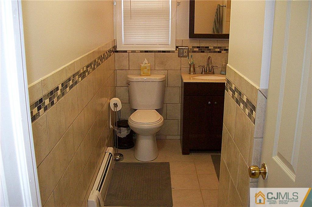 23 Rodney Road East Brunswick, NJ 08816 - Photo 21 of 25 a bathroom with a sink and toilet