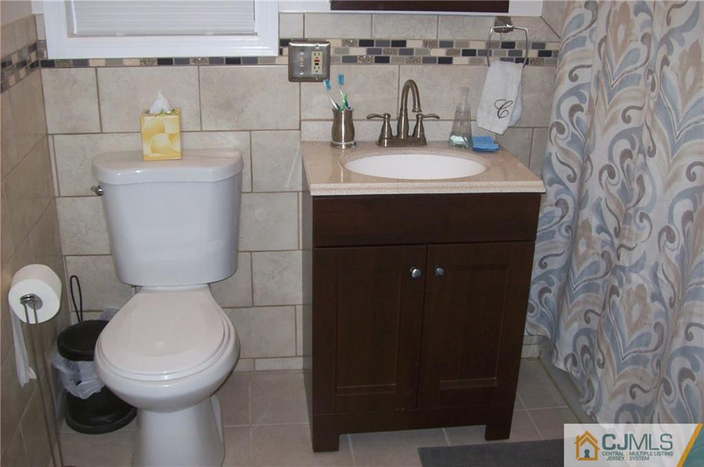 23 Rodney Road East Brunswick, NJ 08816 - Photo 23 of 25 a bathroom with a toilet and a sink
