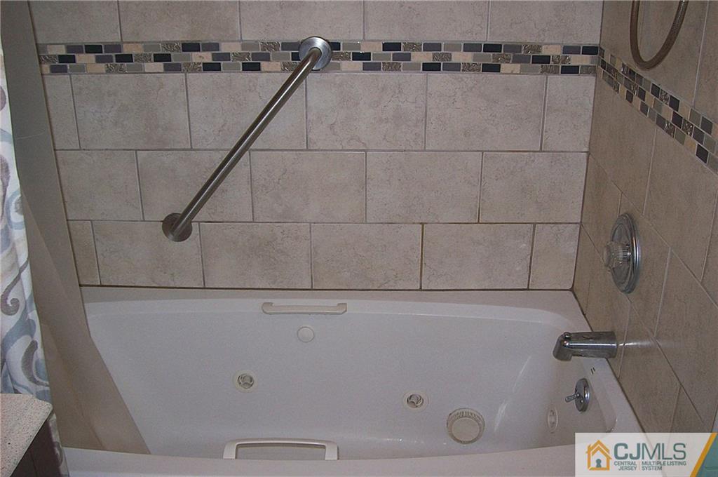 23 Rodney Road East Brunswick, NJ 08816 - Photo 24 of 25 a close view of a shower in the bathroom