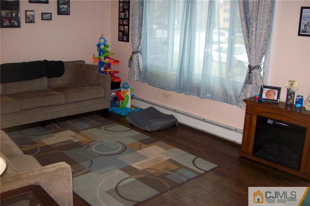 23 Rodney Road East Brunswick, NJ 08816 - Photo 6 of 25 a living room with furniture and a fireplace