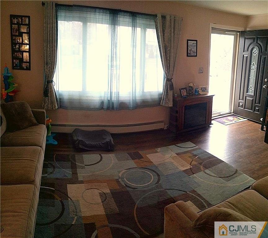 23 Rodney Road East Brunswick, NJ 08816 - Photo 7 of 25 a living room with furniture and a window