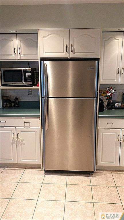 23 Rodney Road East Brunswick, NJ 08816 - Photo 10 of 25 a kitchen with granite countertop a refrigerator and a stove top oven