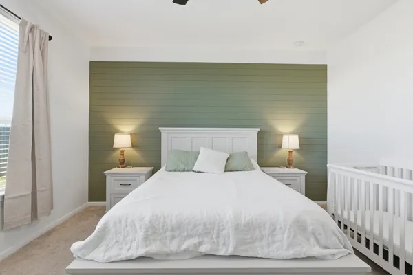 a bedroom with a bed and a night stand