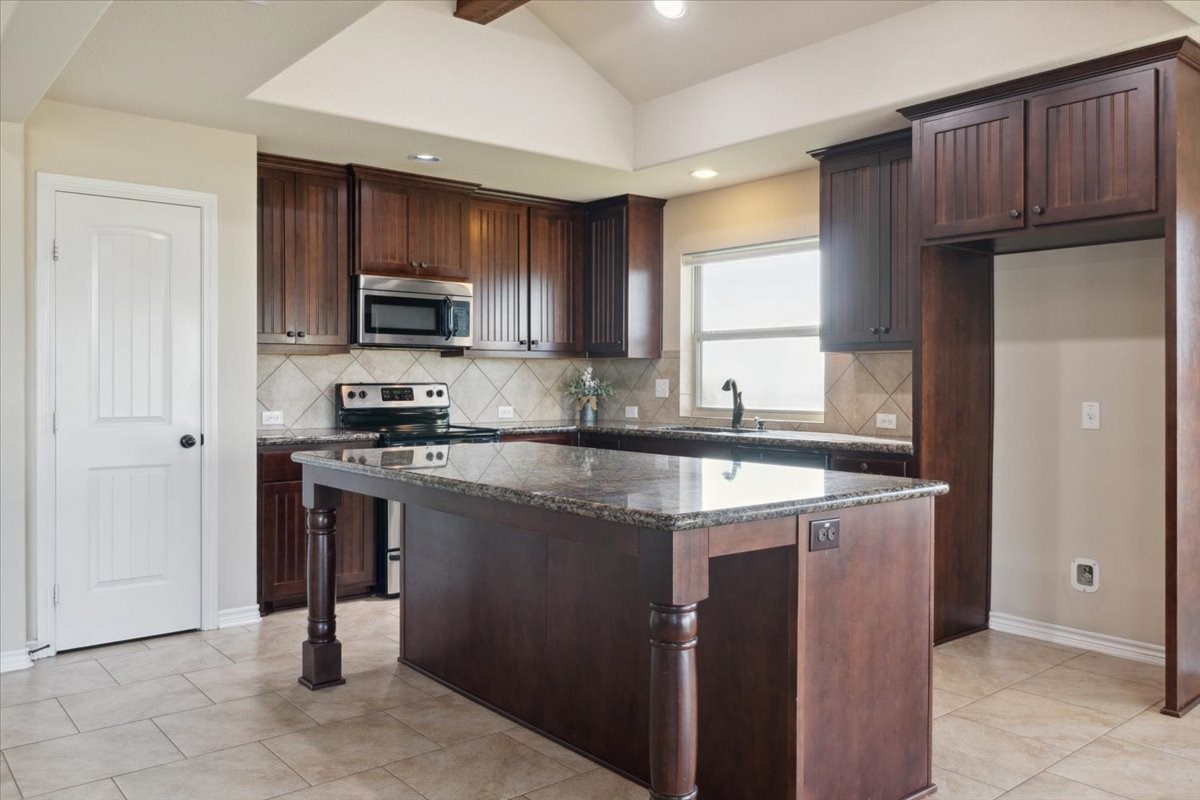 2407 Thuesen Road Beasley, TX 77417 - Photo 14 of 34 a kitchen with stainless steel appliances granite countertop a refrigerator stove a sink and a microwave