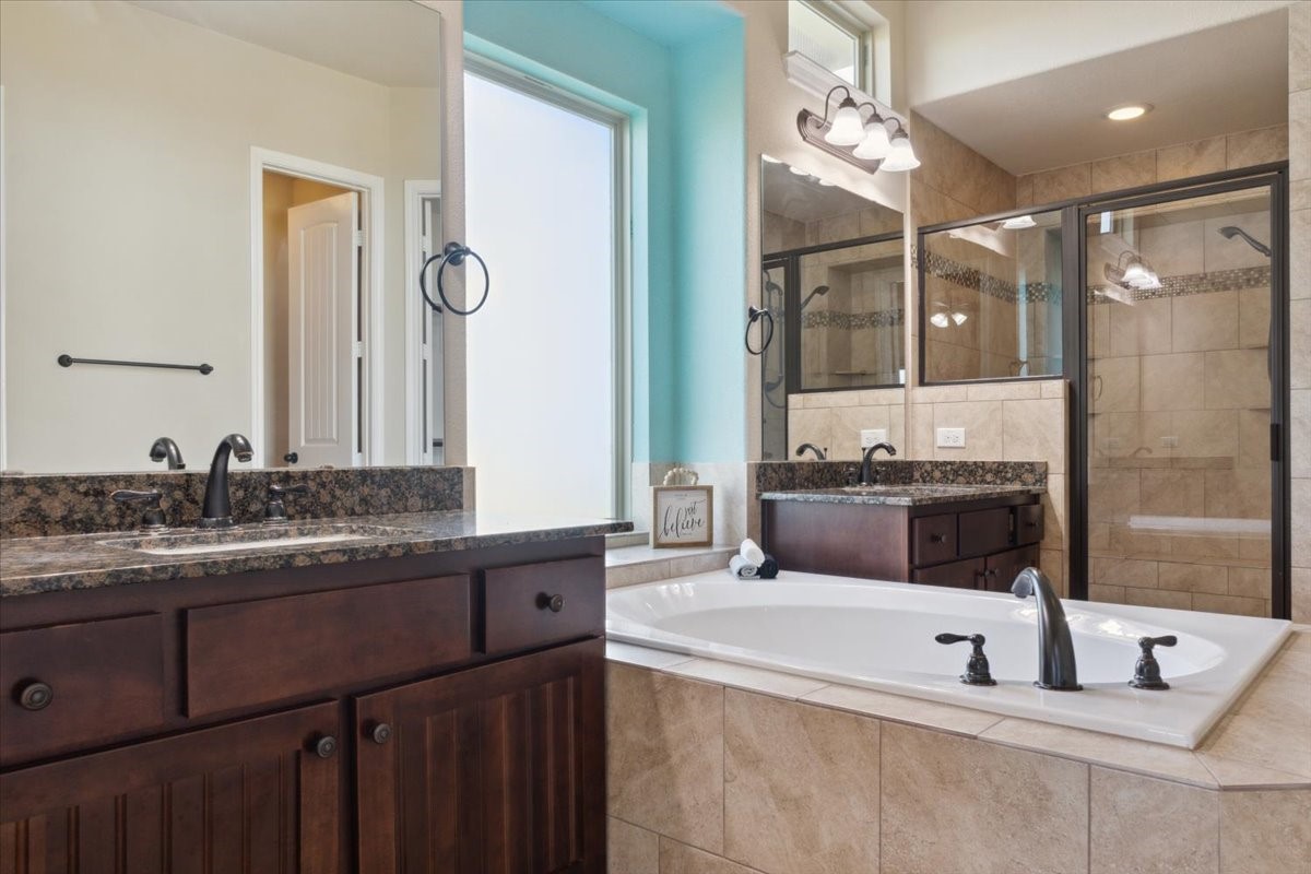 2407 Thuesen Road Beasley, TX 77417 - Photo 20 of 34 a spacious bathroom with a granite countertop sink mirror and bathtub