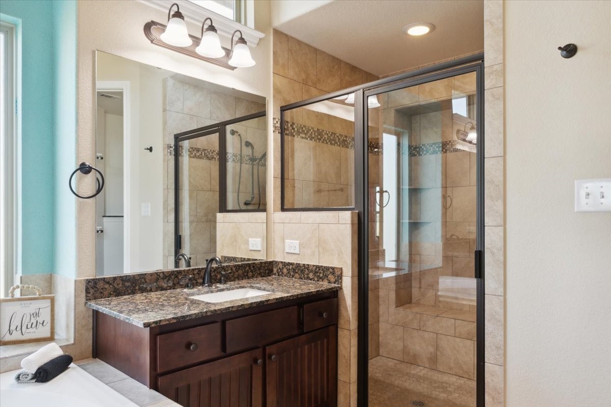 2407 Thuesen Road Beasley, TX 77417 - Photo 21 of 34 a bathroom with a granite countertop sink a mirror and a shower