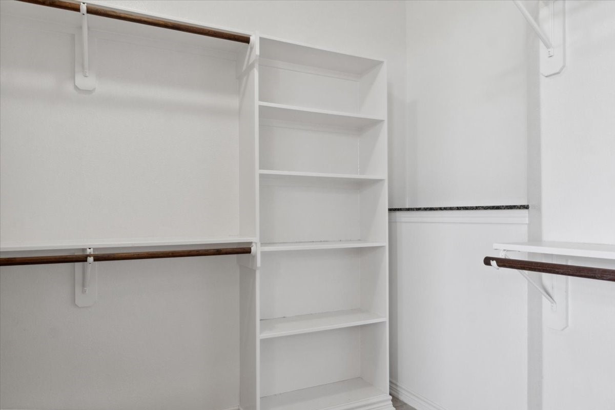 2407 Thuesen Road Beasley, TX 77417 - Photo 23 of 34 a view of walk in closet with empty racks