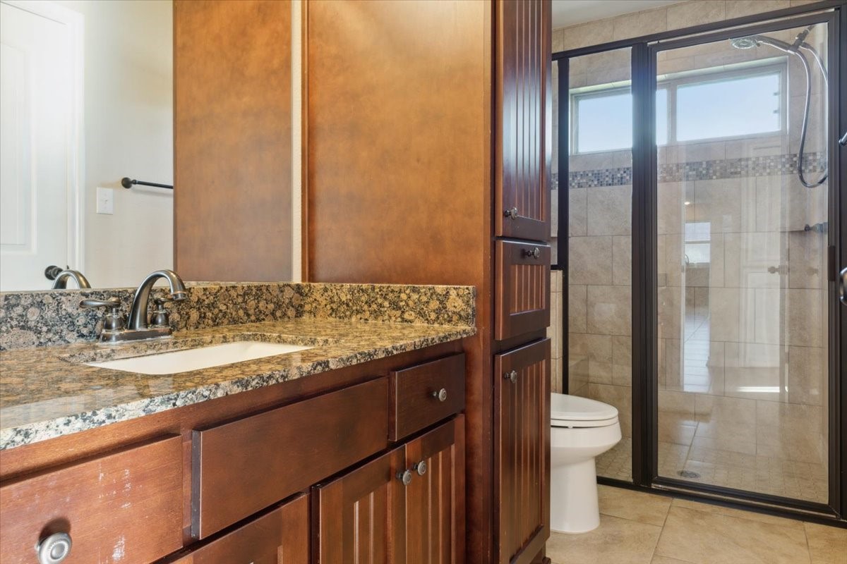 2407 Thuesen Road Beasley, TX 77417 - Photo 27 of 34 a bathroom with a granite countertop sink and a mirror