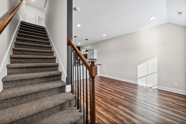 a view of entryway and hall with wooden floor